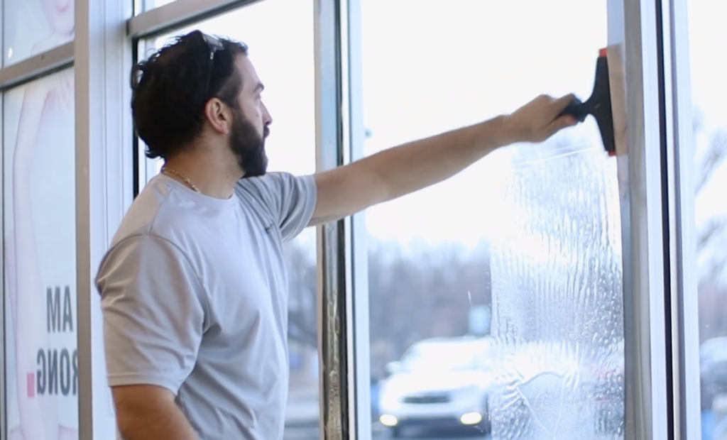 Man applying 3M window film